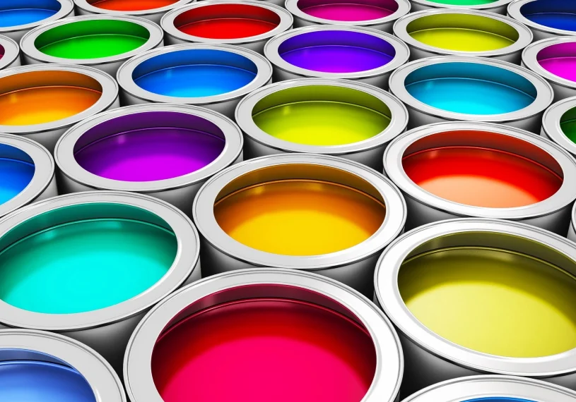 Rows of open paint cans displaying a variety of bright colors, including red, blue, green, and purple.